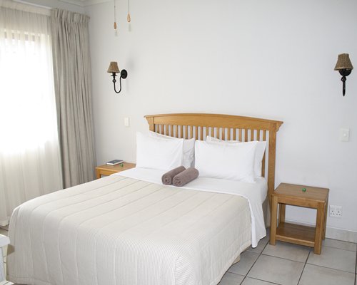 A well furnished bedroom with an outside view.