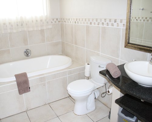 A bathroom with shower and bathtub.