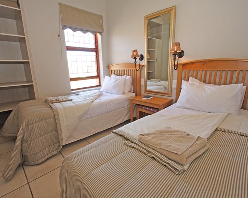 A well furnished bedroom with two twin beds.