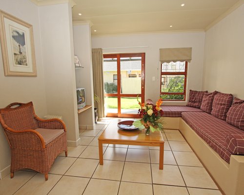 A well furnished living room with television and outdoor view.