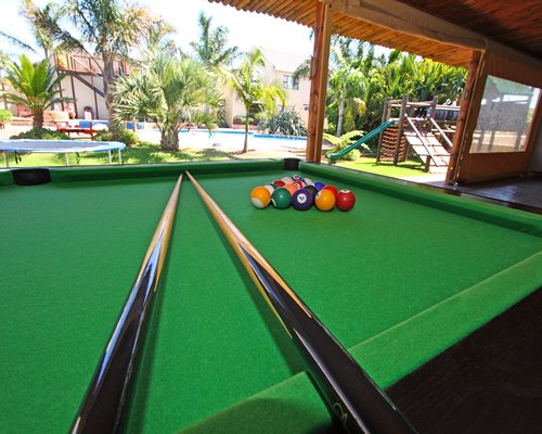 Indoor recreation room with pool table and outside playground.