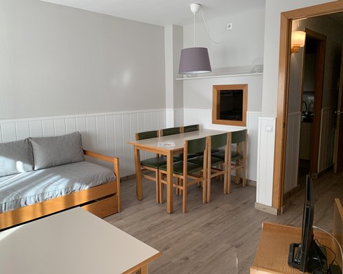 A well furnished living room and bedroom with outside view.