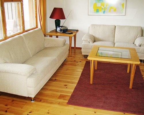 A well furnished living room with two double pull out sofas and a radio.