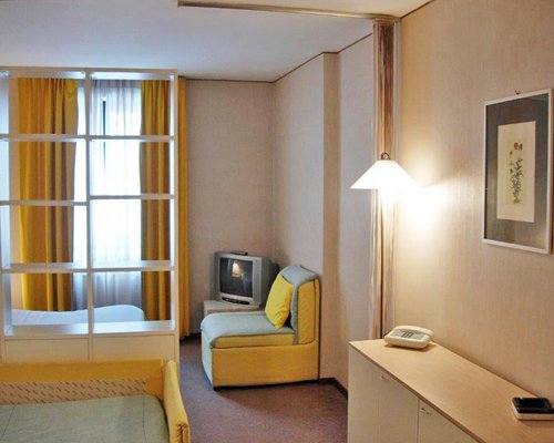 A well furnished bedroom with a television.