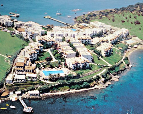 An aerial view of buildings alongside the sea.
