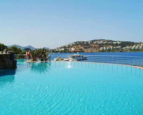 A large outdoor swimming pool alongside the sea.