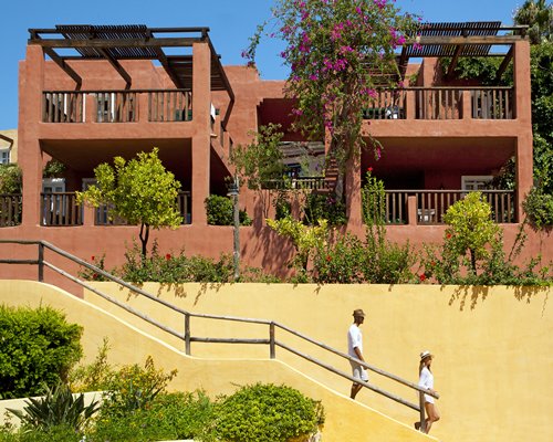 Exterior view of multiple unit balconies with a stairway.