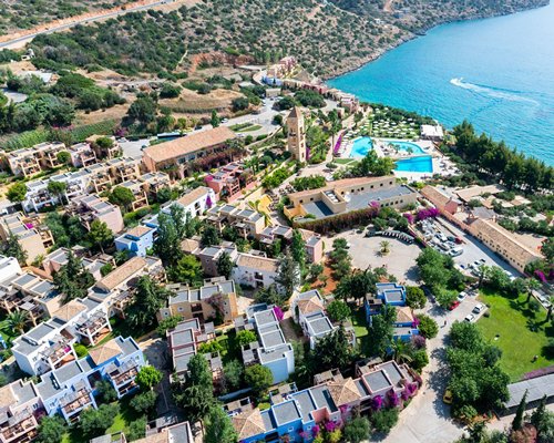 An aerial view of buildings alongside the sea.
