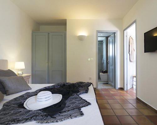 A well furnished bedroom with television.