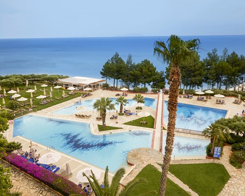 An aerial view of outdoor swimming pool alongside the sea.
