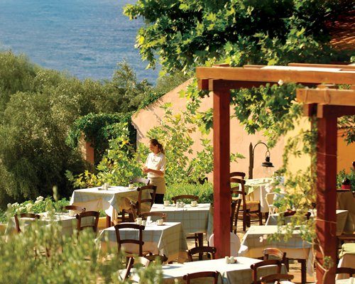 An outdoor fine dining area alongside waterfront.