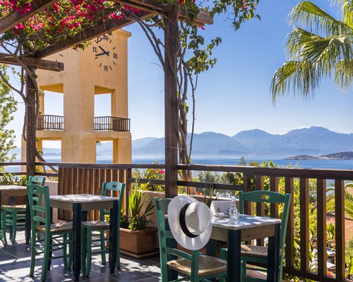 Scenic view of restaurant with multiple dining tables facing the beach.