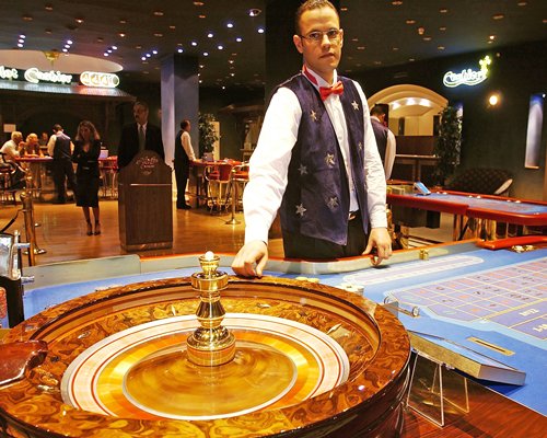 Indoor recreation room with casino tables.