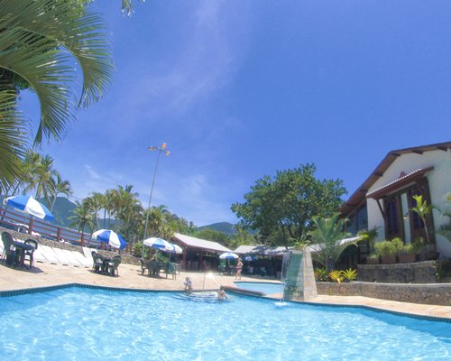 An outdoor swimming pool alongside resort condos.