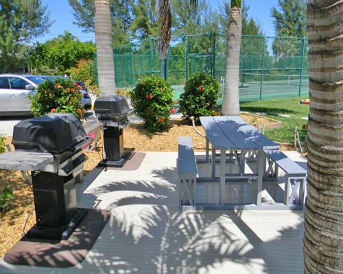 A picnic table with a barbecue grill.