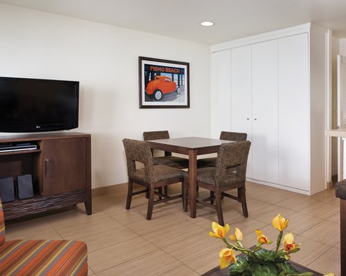 An open plan living and dining area with a television.