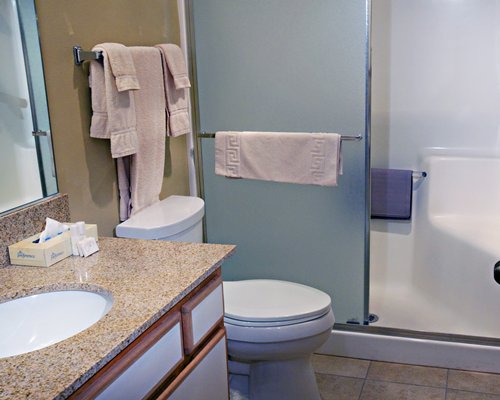 A bathroom toilet with sink vanity.