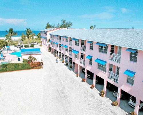Scenic exterior view of Gulf Stream Beach Resort with basement car parking alongside swimming pool.