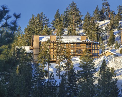 Scenic exterior view of WorldMark Tahoe II during the winter surrounded by snow.