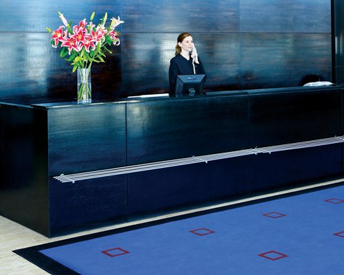 A woman speaking on the phone at the reception area.