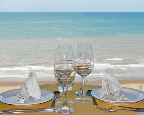 A dining area alongside the ocean.