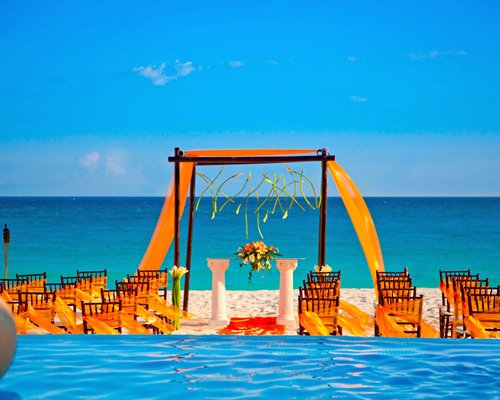 A view of beach wedding set up alongside the ocean.