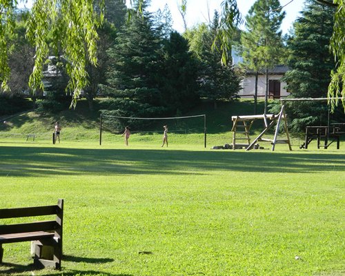 An outdoor children's play area surrounded by woods.