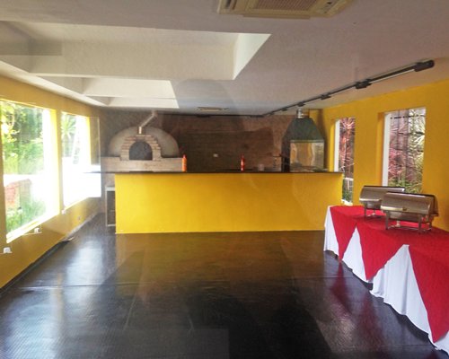 Room with a buffet and fireplace.