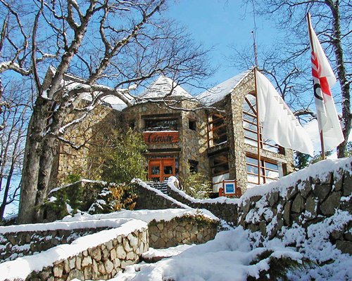 An exterior view of the Paihuen resort covered in snow.