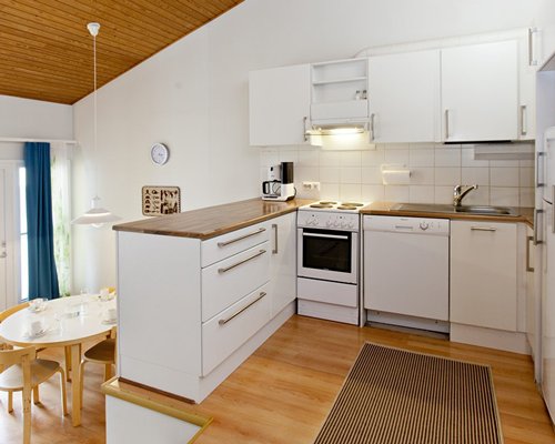A well equipped kitchen and a dining area.