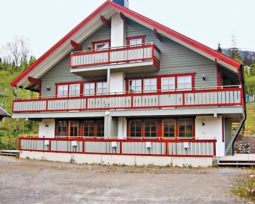 Exterior view of Holiday Club Tegefjall resort surrounded by wooded area.