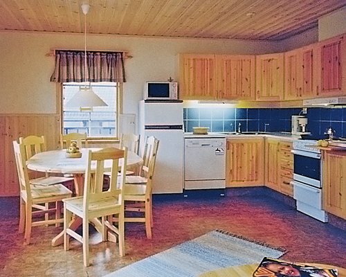An open plan kitchen with dining area and outside view.
