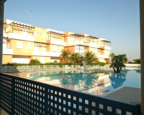 A large outdoor swimming pool alongside multiple units of the resort.