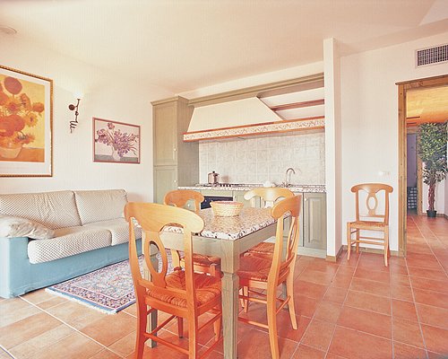 An open plan furnished living room with dining and kitchen area.