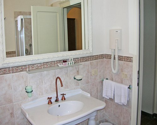 A bathroom with an open sink and vanity.