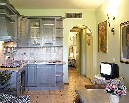 An open plan kitchen dining area with a television.