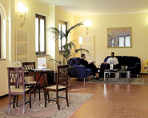 An open plan dining and living area with sofas.