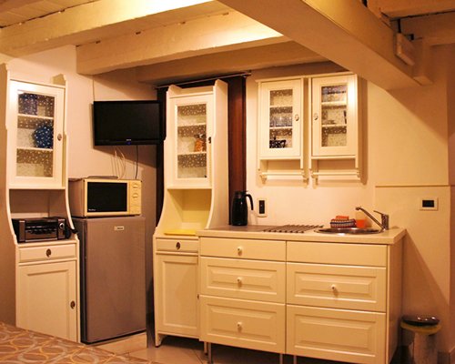 A well equipped kitchen with a television.
