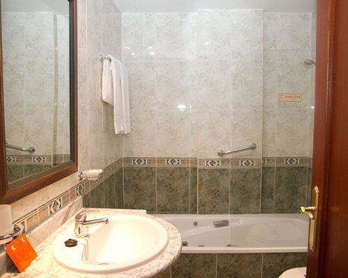 A bathroom with shower stall and sink vanity.