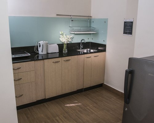 A well equipped kitchen with a sink and refrigerator.