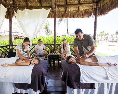 A couple enjoying a massage at an outdoor spa.