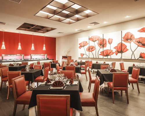 A restaurant interior with multiple dining tables.
