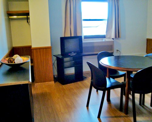A well furnished dining area with a television.
