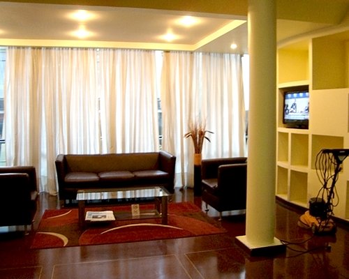 A well furnished living room with television and an outside view.