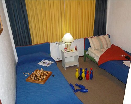 A well furnished bedroom with a chessboard.