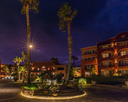 A street view of multi story condos at dusk.