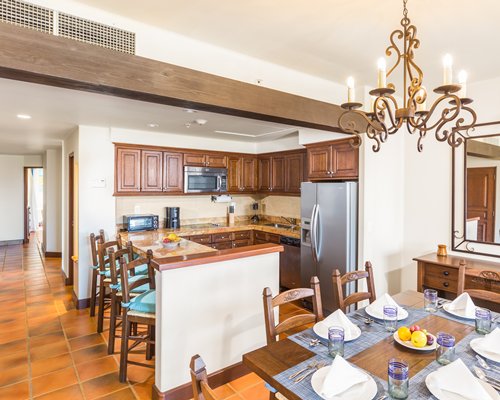 An open plan dining and kitchen area with a breakfast bar.