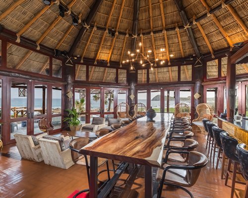 Indoor restaurant area with outside view at Hacienda del Mar Resort.