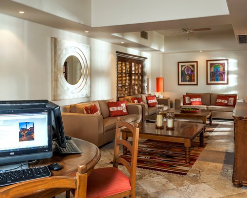 A furnished common room with computers and sofas.