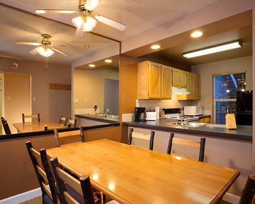 A well furnished indoor dining area alongside a kitchen.
